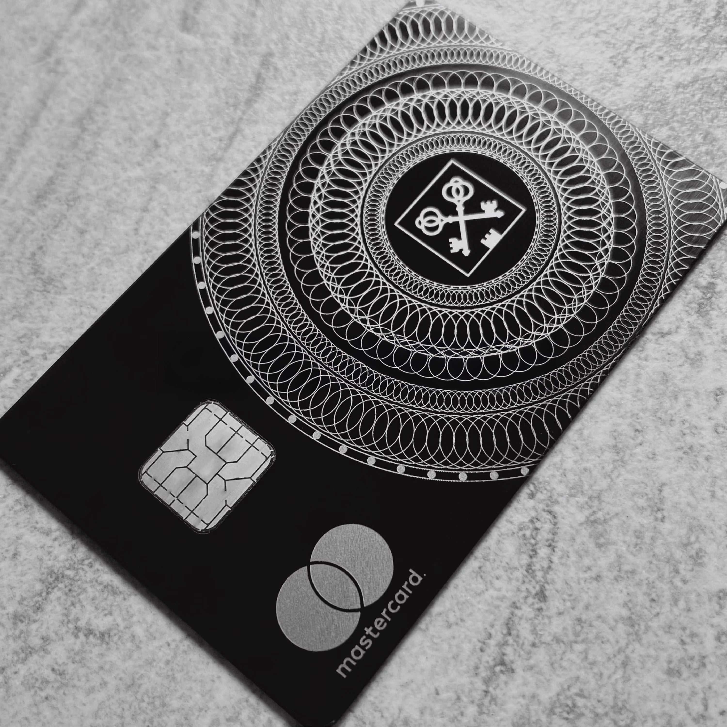 Elite Goldman Lampe black metal card with intricate engraved detailing for luxury branding